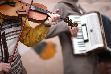 Music band performance; hands of violincellist in focus