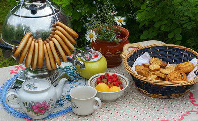Russian tableful with samovar in the garden