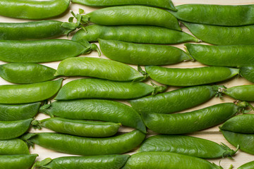pea pods on a wooden surface