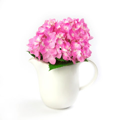 Obraz na płótnie Canvas sweet hydrangea flowers in white vase on a white background