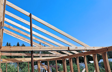 Installation of wooden beams at construction the roof truss syst