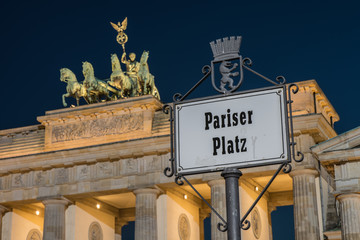 Brandeburg Gate in the Evening (German: Brandenburger Tor). In the foreground the Pariser Platz sign
