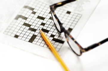 Crossword puzzle and pencil,reading glasses