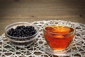 Glass Tea Cup With Herbal Tea And Plate With Blueberries