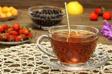 Glass Tea Cup With Herbal Tea And Plate With Barries