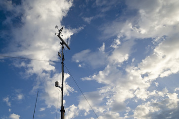 Obraz premium Anemometer and wind vane on blue sky