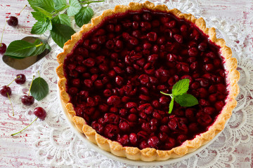 Homemade cherry pie, shortbread dough and cherry jelly on top