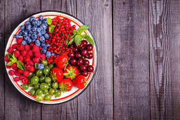 Set of summer berries on a wooden background