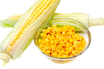 Bowl of corn and cobs on a white background