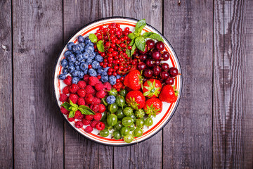 Set of summer berries on a wooden background