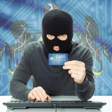 Hacker holding credit card and USA state flag - Pennsylvania