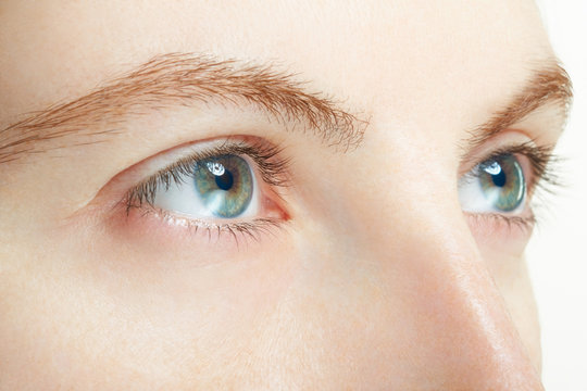 Woman blue eyes macro, vision concept