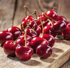 Ripe red cherries on old boards