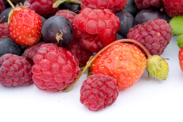 healthy eating concept: different fresh berries, strawberries, raspberries, black currants and grossberies macro shot