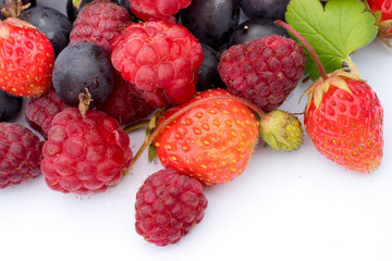 healthy eating concept: different fresh berries, strawberries, raspberries, black currants and grossberies macro shot