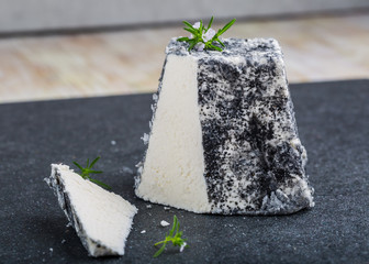 Goat cheese Valencay on a black background