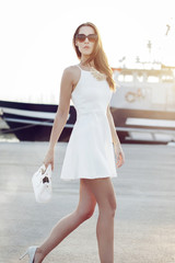 Young fashionable woman posing at boat