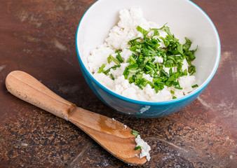 Goat curd with fresh herbs in a bowl