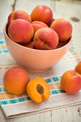 Fresh homegrown apricots on vintage white wooden table