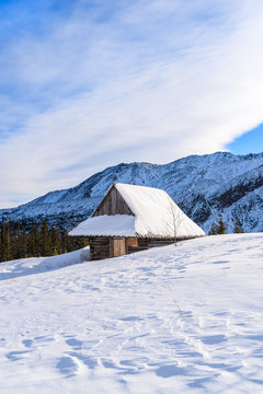 Wooden mountain hut in winter landscape of Gasienicowa valley, Tatra Mountains, Poland