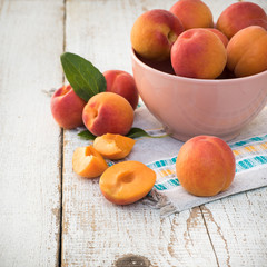 Fresh homegrown apricots on vintage white wooden table
