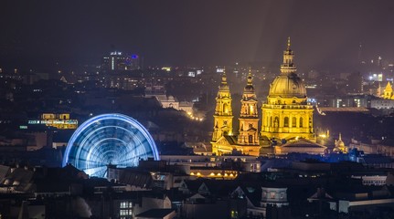 Night view over ferris wheel and cupola of basilica of saint istvan taken from gellert hegy hill.