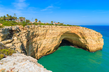 Fototapeta na wymiar Cliff cave and turquoise ocean on coast of Portugal near Carvoeiro town, Algarve region