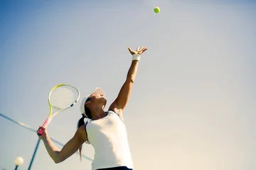 Zelfklevend Fotobehang Beautiful female tennis player serving © NDABCREATIVITY