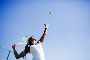  Beautiful female tennis player serving © NDABCREATIVITY