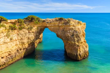 Foto op Plexiglas Marinha Beach, Algarve, Portugal Rock cliff arch near Marinha beach and blue sea on coast of Portugal in Algarve region