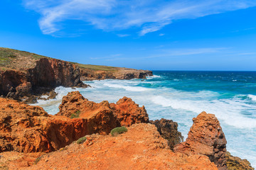 Fototapeta na wymiar Sea waves at Praia do Bordeira beach, famous place for windsurfing, Algarve region, Portugal