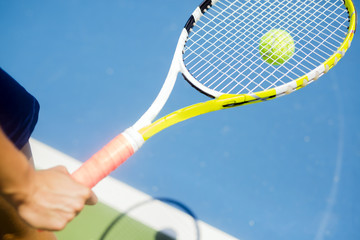 Closeup of a player holding the racquet warming up