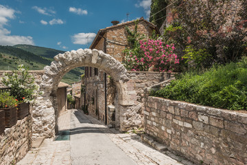 Old rocky arch over the street in Spello, Umbria
