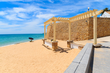 Greek style construction on beach in Armacao de Pera coastal town, Algarve region, Portugal