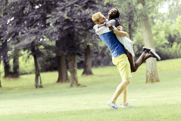 Obraz premium Portrait of a happy couple dancing and hugging in nature outdoor