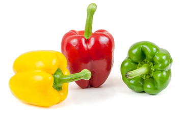 Three colored peppers on white background