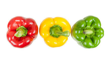 Top view of three colored peppers on white