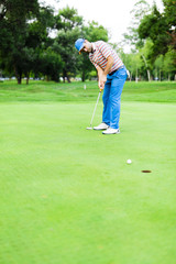 Golfer takes the putting green shot
