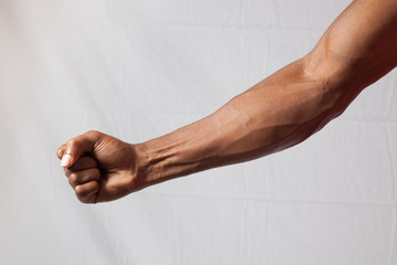 Man's arm and fist - obrazy, fototapety, plakaty