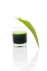 Green juice in glass isolated.
