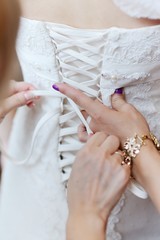 bridesmaid corset laces on a wedding dress