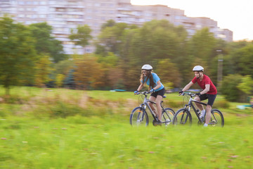 Naklejka premium Cycling Concept: Young Caucasian Couple Having a Speedy Bicycle