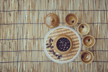 Coffee beans and coffee cup set on bamboo wooden background.Phot