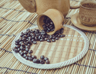 Coffee beans and coffee cup set on bamboo wooden background.Phot
