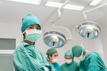 Fototapeta na wymiar Surgical team with arms crossed in an operating theater