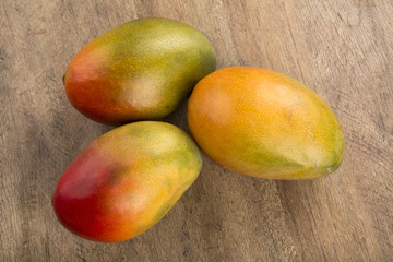 mango on a wood background.