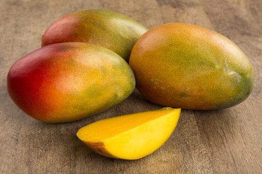 mango on a wood background.