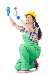 Female workman in green overalls holding key isolated on white