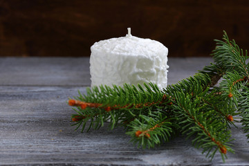 White candle with pine branches