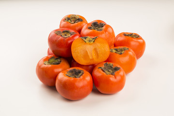 Some khaki fruits over a wooden surface